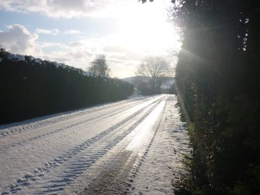 Low Winter sunlight on snowy road | The Askanagap Community Development Association