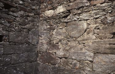 8. Two D-shaped stones built into the north-west corner of the nave (J. Scarry). | Courtesy of Con Manning & Wordwell Publishing