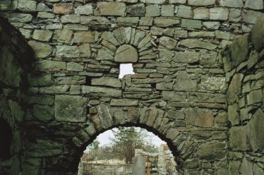 9. An external view of the original east window of Confey church with D-shaped stone tympanum in place. The lower part of this window was removed when a chancel arch was inserted in the wall (C. Manning). | Courtesy of Con Manning & Wordwell Publishing