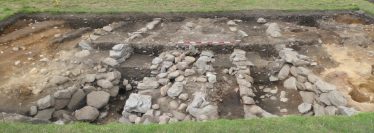 Fig. 7—The up-to-8m wide ditch (dark soils) located between the main monastic complex and St Mary’s church at the Lower Lake. The multiple stone walls and façades may be related to water management. | Courtesy of Glendalough Heritage Froum and Wordwell Publishing